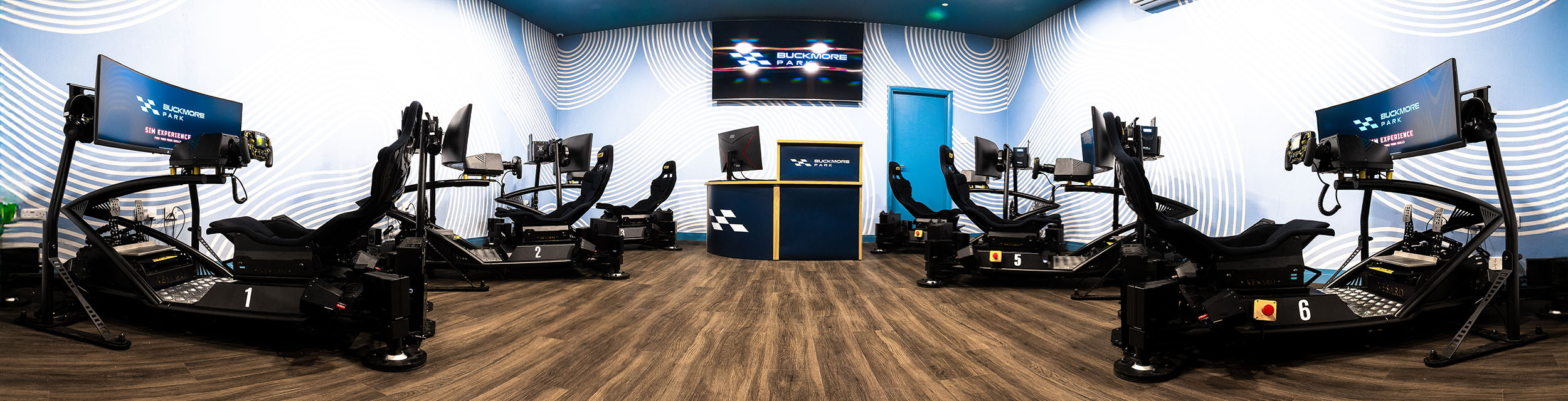 Panoramic view of the simulator room at Buckmore Park with six racing simulators